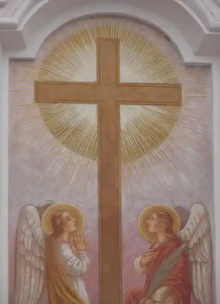 A solar cross with two angels on a Christian church.